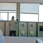 Two men stand in the men's toilet